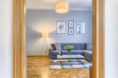 a living room with a blue couch and a table at Spacious And Bright Apartment Dusni 13 in Prague
