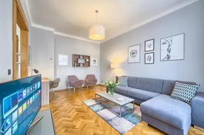 a living room with a couch and a tv at Spacious And Bright Apartment Dusni 13 in Prague