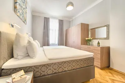 a bedroom with a large bed with a mirror at Spacious And Bright Apartment Dusni 13 in Prague