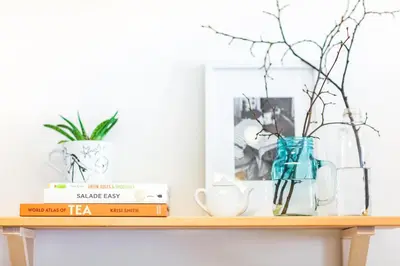 a wooden shelf with books and a vase on it at Trendy Local Apartment in Prague
