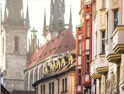 a row of buildings in a city with cathedral at Trendy Local Apartment in Prague