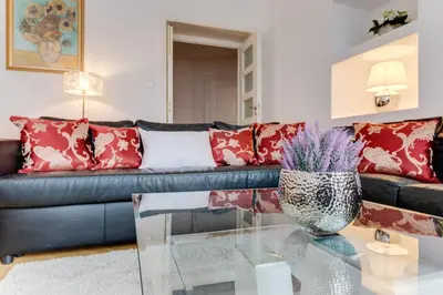 a living room with a couch and a glass table at Old Town Square Royal Apartment in Prague
