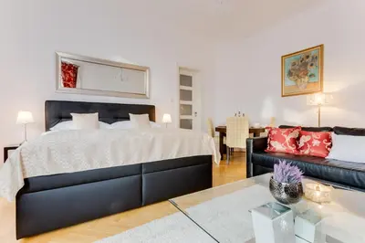 a bedroom with a large bed and a couch at Old Town Square Royal Apartment in Prague