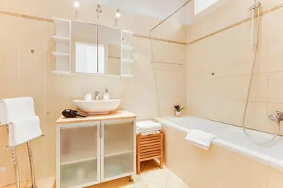 a bathroom with a tub and a sink and a bath tub at Old Town Square Royal Apartment in Prague