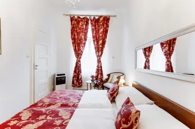 a bedroom with two beds and a window at Old Town Square Royal Apartment in Prague