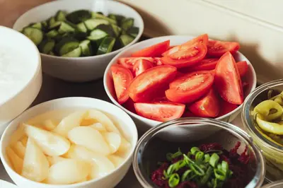 a group of bowls of vegetables on a table at Alqush Downtown Hotel in Prague