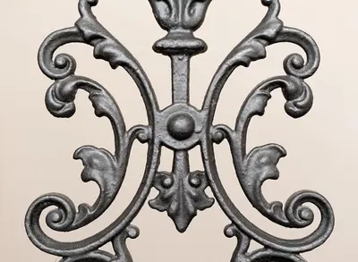 an antique wrought iron fence in front of a wall at Alqush Downtown Hotel in Prague