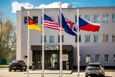 three flags flying in front of a hotel at Skyhotel Prague in Prague