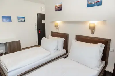 two beds in a hotel room with white pillows at Skyhotel Prague in Prague