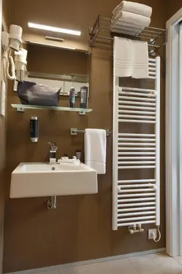a bathroom with a white sink and towels at Skyhotel Prague in Prague