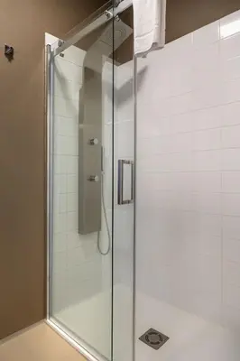 a shower with a glass door in a bathroom at Skyhotel Prague in Prague