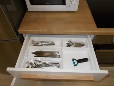 a white drawer with silver utensils on a counter at Neklanova Apartments in Prague