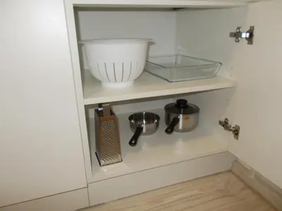 a shelf in a kitchen with a bowl and utensils at Neklanova Apartments in Prague