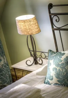 a lamp sitting on a bed next to a pillow at Black Star Suites in Prague