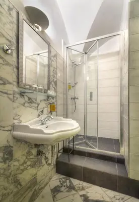 a bathroom with a sink and a shower at Black Star Suites in Prague