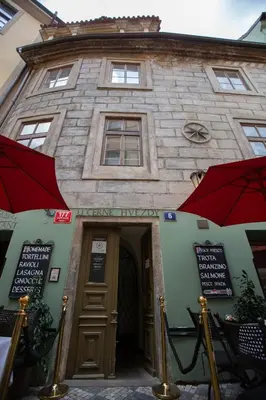 a building with a red umbrella in front of it at Black Star Suites in Prague
