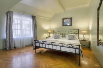 a bedroom with a bed and a large window at Black Star Suites in Prague