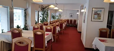 a row of tables and chairs in a restaurant at Hotel Legie in Prague