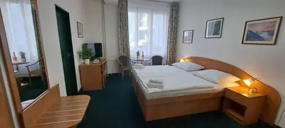 a bedroom with a large bed in a room at Hotel Legie in Prague