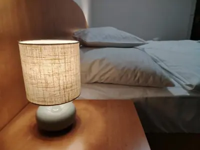 a lamp sitting on a table next to a bed at Hotel Legie in Prague