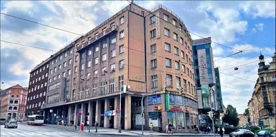 a large brick building on a city street at Hotel Legie in Prague
