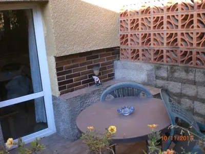 a wooden table and chairs on a patio at pension Kalik in Prague