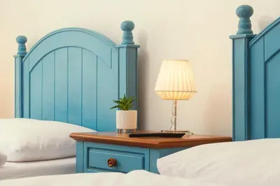 a bedroom with two beds and a table with a lamp at Ostende Chocerady - ubytování u řeky in Chocerady