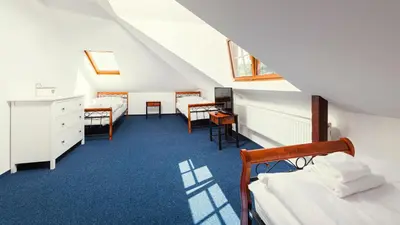 a room with two beds and a table and chairs at Ostende Chocerady - ubytování u řeky in Chocerady