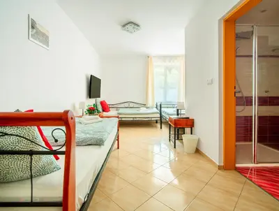 a bedroom with two bunk beds and a living room at Ostende Chocerady - ubytování u řeky in Chocerady