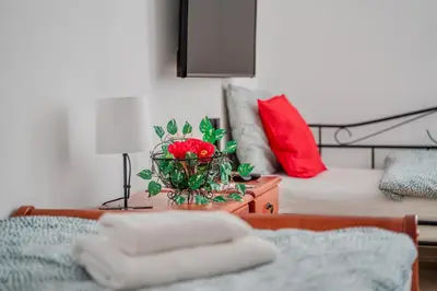 a living room with a bed and a table with towels at Ostende Chocerady - ubytování u řeky in Chocerady