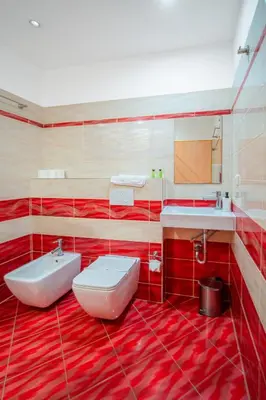 a red bathroom with a sink and a toilet at Ostende Chocerady - ubytování u řeky in Chocerady