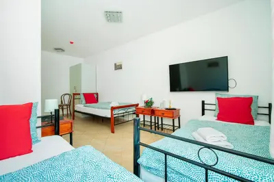 a room with two beds and a flat screen tv at Ostende Chocerady - ubytování u řeky in Chocerady