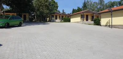 a parking lot with a green car parked in front of houses at Resort Beach Nová Živohošť in Křečovice