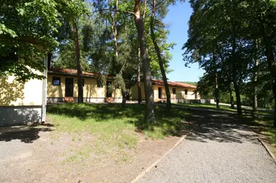 a house with trees in front of it at Resort Beach Nová Živohošť in Křečovice