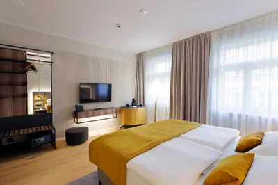 a hotel room with two beds and a television at Hotel Prokop Square in Prague