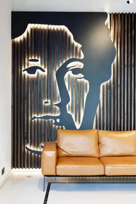 a couch in a room with a painting of a woman at Hotel Prokop Square in Prague