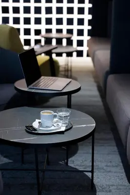 a table and chairs with wine glasses on it at Hotel Prokop Square in Prague