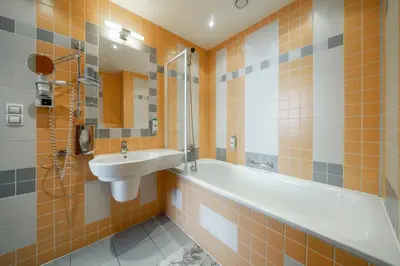 a bathroom with a sink and a bath tub and a sink at Penzion Homer Poděbrady in Poděbrady