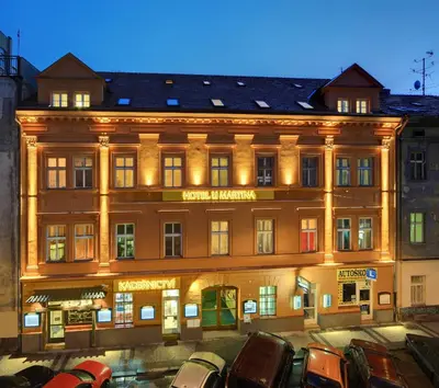 a large building with cars parked in front of it at Martin Hotel Prague in Prague