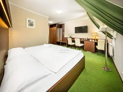 a hotel room with a bed and a dining room at Martin Hotel Prague in Prague