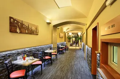 a dining room with tables and chairs in a restaurant at Martin Hotel Prague in Prague