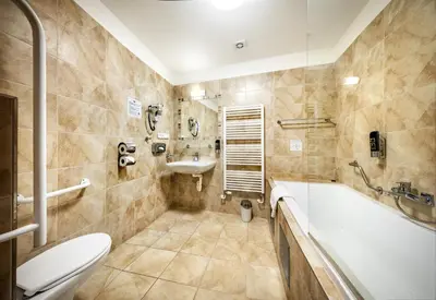 a bathroom with a tub and a sink and a toilet at Martin Hotel Prague in Prague