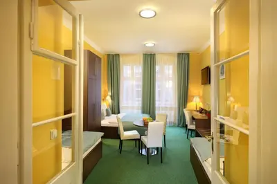 a hotel room with a bed and a dining room at Martin Hotel Prague in Prague