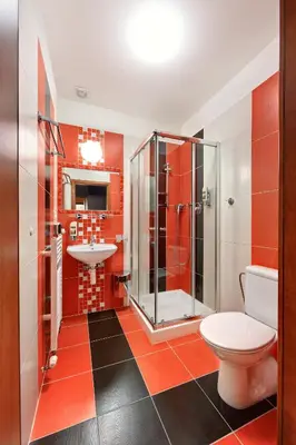a bathroom with a shower and a toilet and a sink at Martin Hotel Prague in Prague