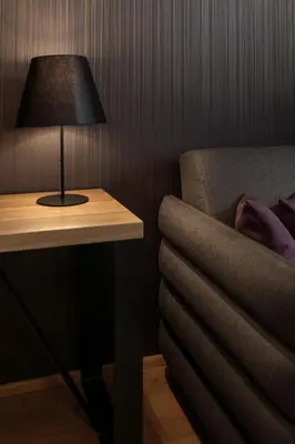 a lamp sitting on a table next to a bed at MOODs Charles Bridge in Prague