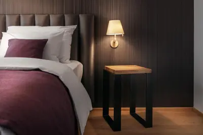 a bedroom with a bed and a table with a lamp at MOODs Charles Bridge in Prague
