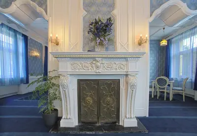 a fireplace in a room with a vase on top of it at Hotel Zámeček in Poděbrady