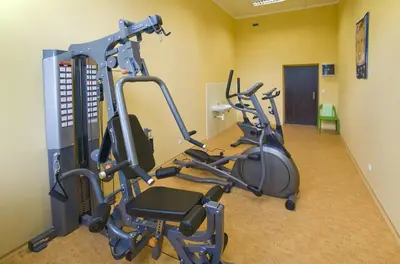 a gym with two exercise bikes in a room at Hotel Zámeček in Poděbrady