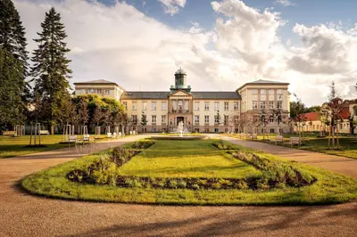 an image of a large building with a large lawn at Hotel Zámeček in Poděbrady