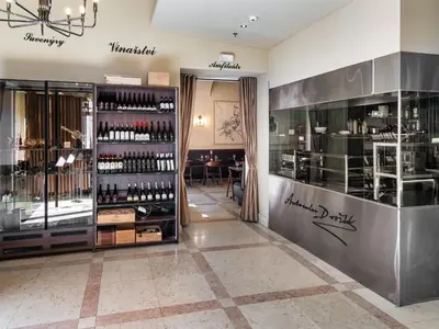 a wine shop with a display case in a room at Maestro by Adrez in Prague